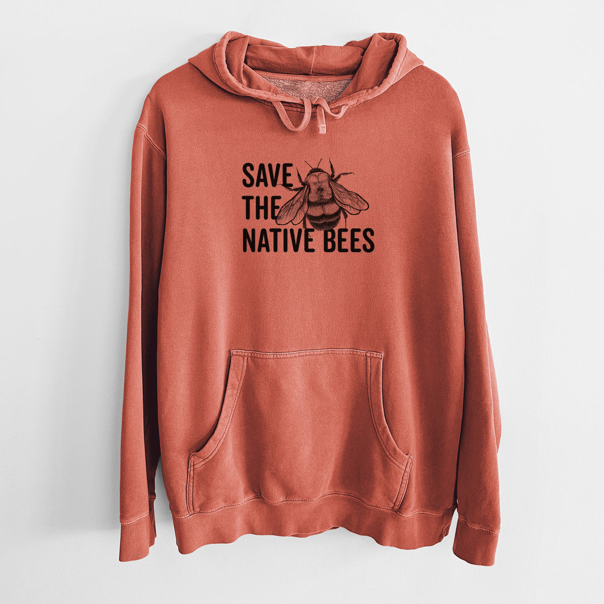 Amber orange pigment dyed hoodie laid flat, printed with bold black words reading Save the Native Bees beside a detailed bee illustration.