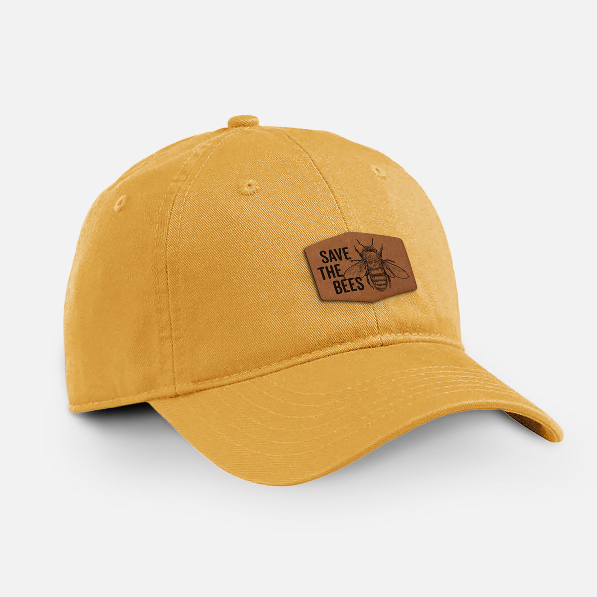 Beehive yellow cotton baseball hat with a brown leather patch engraved with the words Save the Bees and a bee on the front.