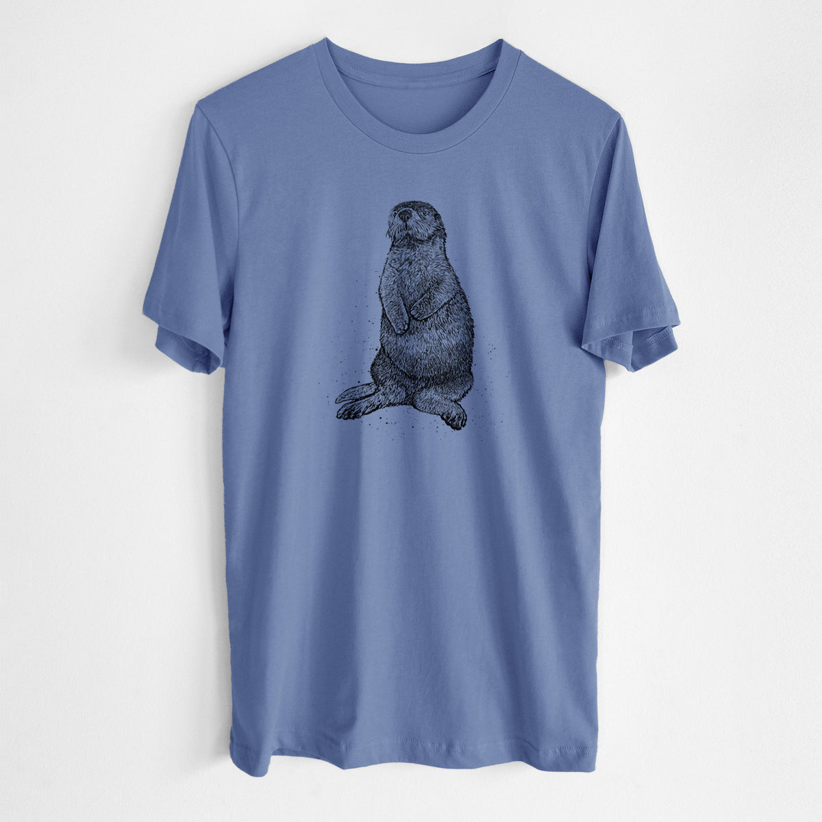 Blue bell lightweight cotton t-shirt laid flat, printed with a detailed black ink illustration of a sea otter sitting upright.