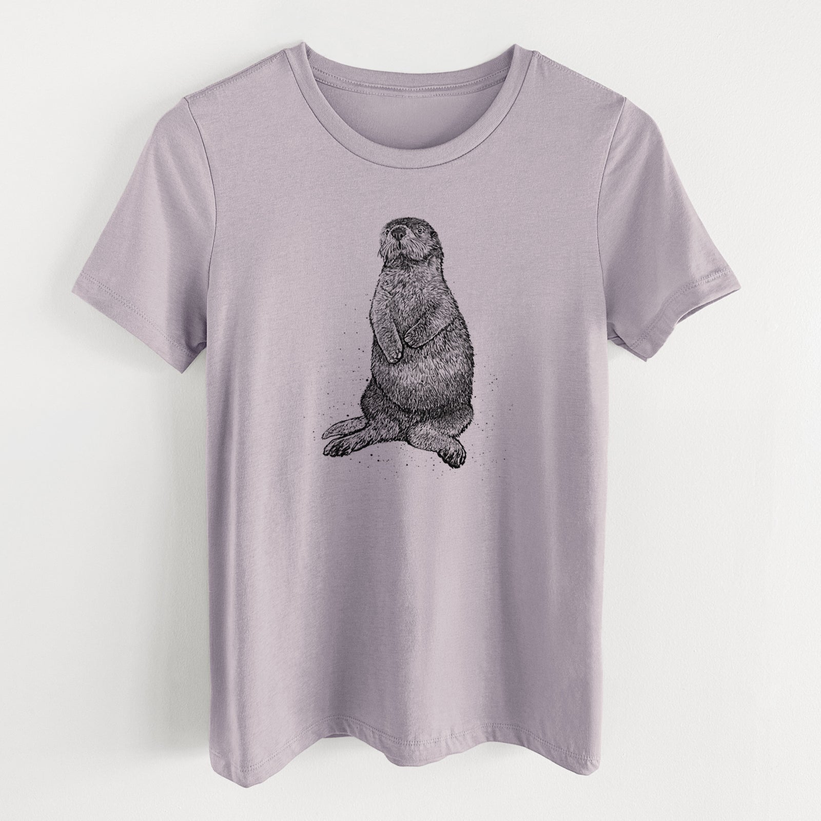 Light violet women's relaxed fit cotton t-shirt laid flat, printed with a detailed black ink illustration of a sea otter sitting upright.
