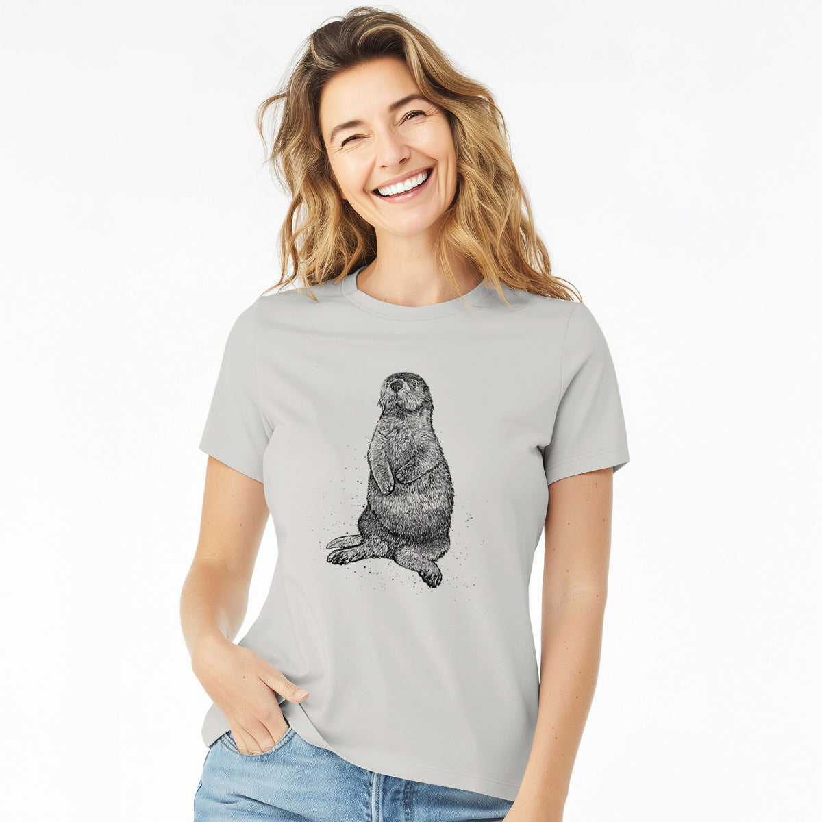 Woman wearing a lunar grey women's relaxed fit cotton t-shirt printed with a detailed black ink illustration of a sea otter sitting upright.