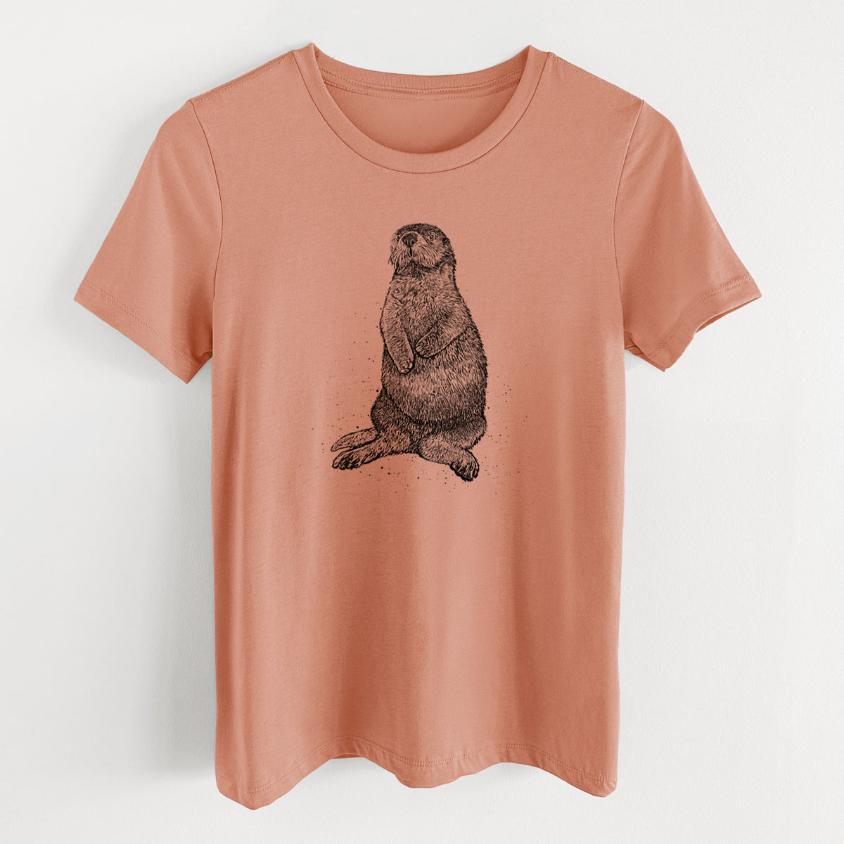 Terracotta orange women's relaxed fit cotton t-shirt laid flat, printed with a detailed black ink illustration of a sea otter sitting upright.