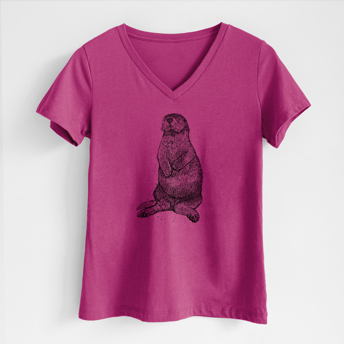 Berry pink women's relaxed fit cotton V-neck t-shirt laid flat, printed with a detailed black ink illustration of a sea otter sitting upright.