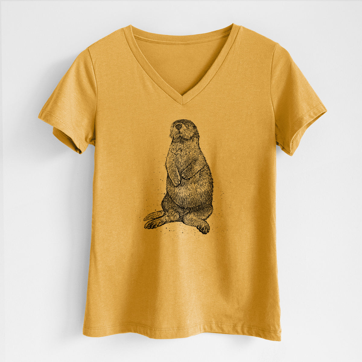 Honeycomb yellow women's relaxed fit cotton V-neck t-shirt laid flat, printed with a detailed black ink illustration of a sea otter sitting upright.