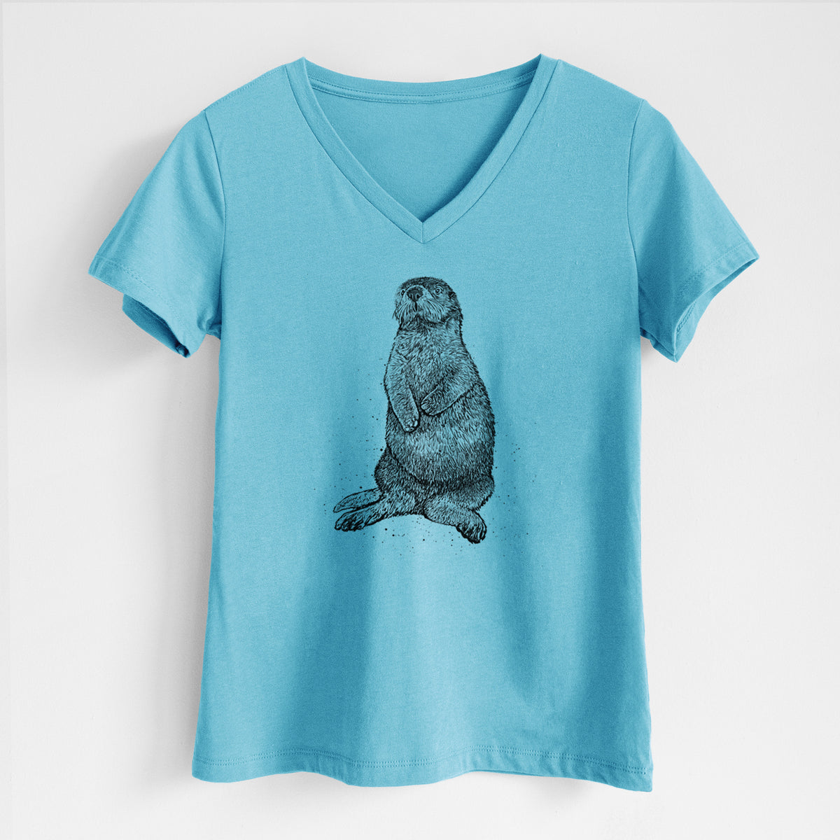 Turquoise women's relaxed fit cotton V-neck t-shirt laid flat, printed with a detailed black ink illustration of a sea otter sitting upright.