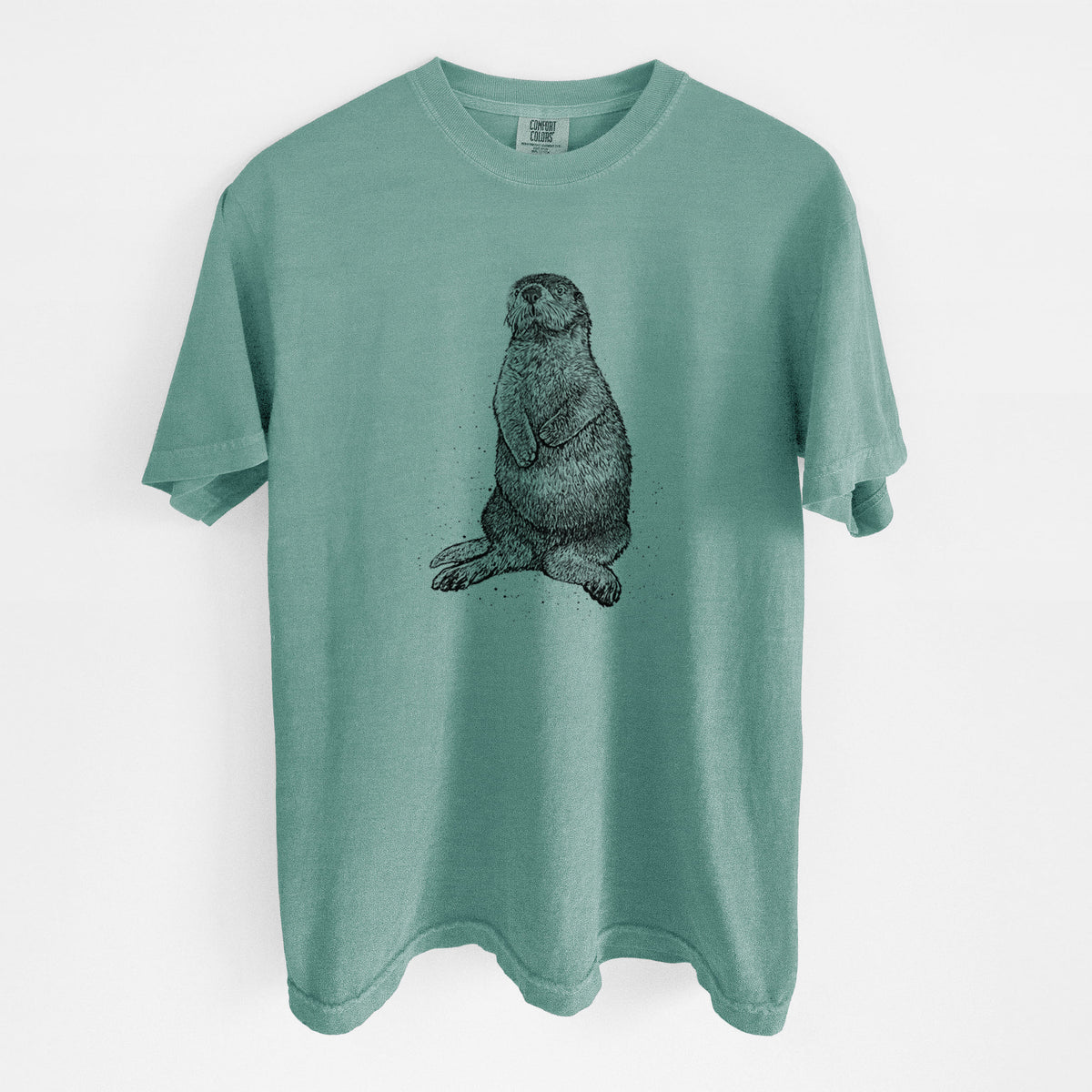 Reef green Comfort Colors t-shirt laid flat, printed with a detailed black ink illustration of a sea otter sitting upright.