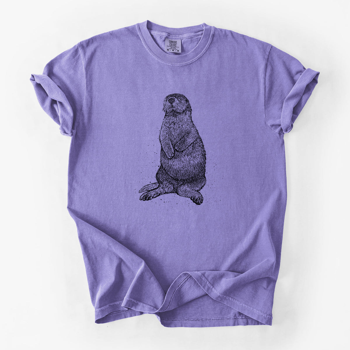 Violet purple Comfort Colors t-shirt laid flat, printed with a detailed black ink illustration of a sea otter sitting upright.
