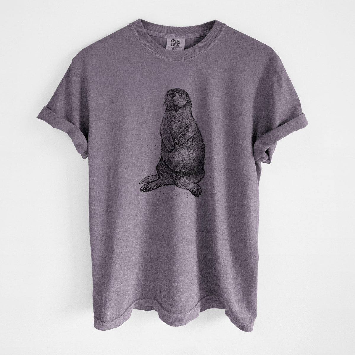 Wine red Comfort Colors t-shirt laid flat, printed with a detailed black ink illustration of a sea otter sitting upright.