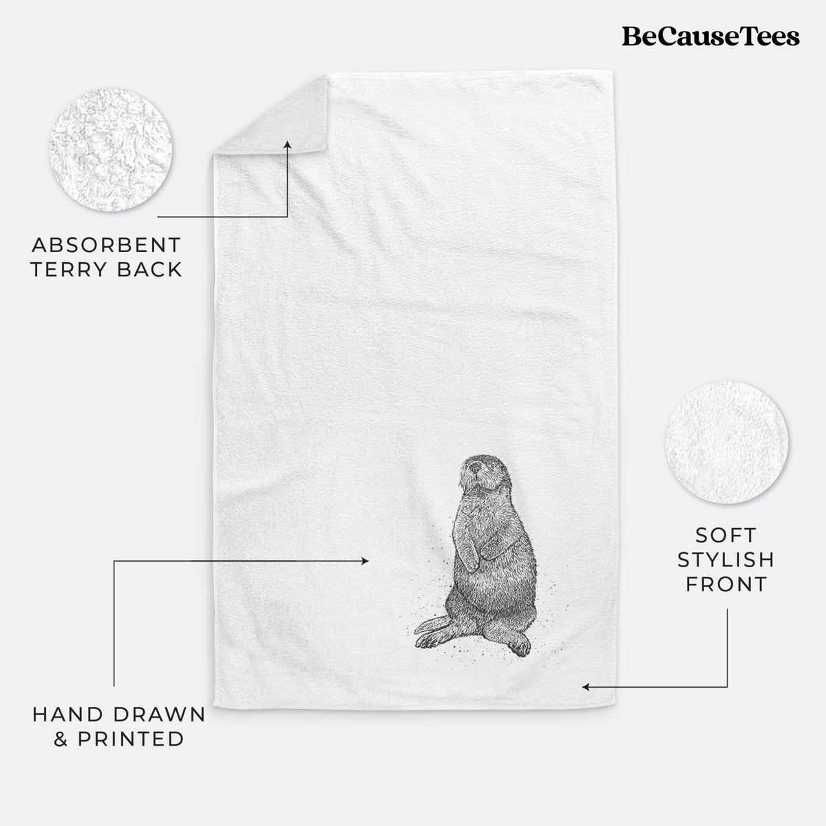 White hand towel printed with a detailed black ink illustration of a sea otter sitting upright.