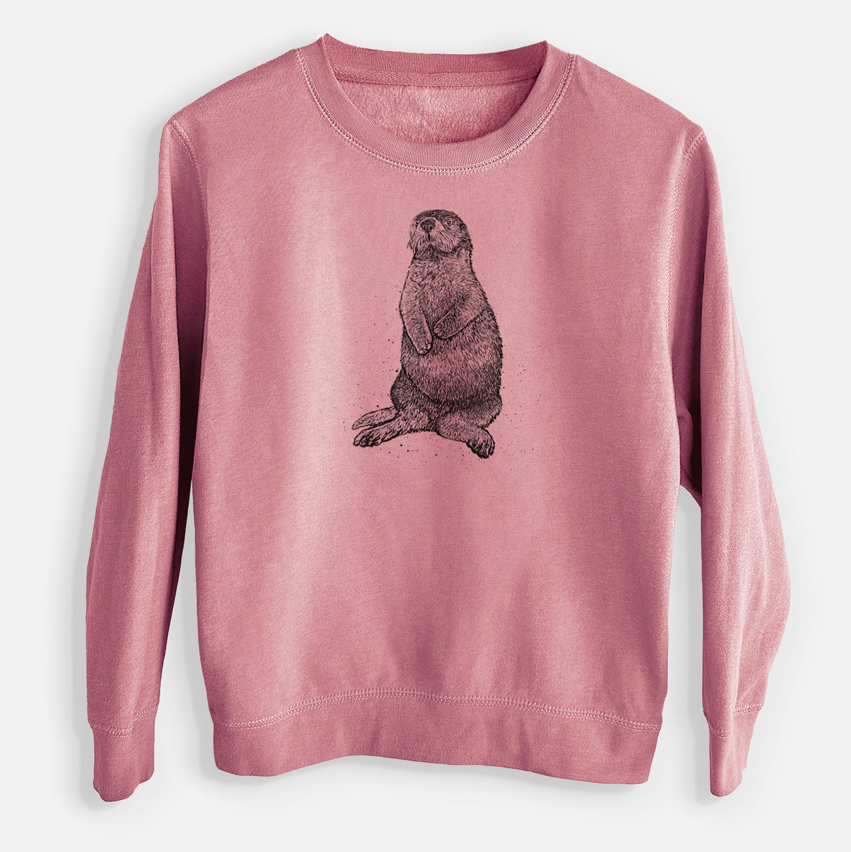 Mauve pink youth crewneck sweatshirt laid flat, printed with a detailed black ink illustration of a sea otter sitting upright.