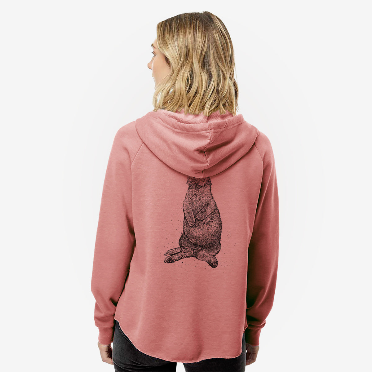 Woman wearing a dusty rose women's Cali Wave zip-up sweatshirt printed with a detailed black ink illustration of a sea otter sitting upright, seen from behind.