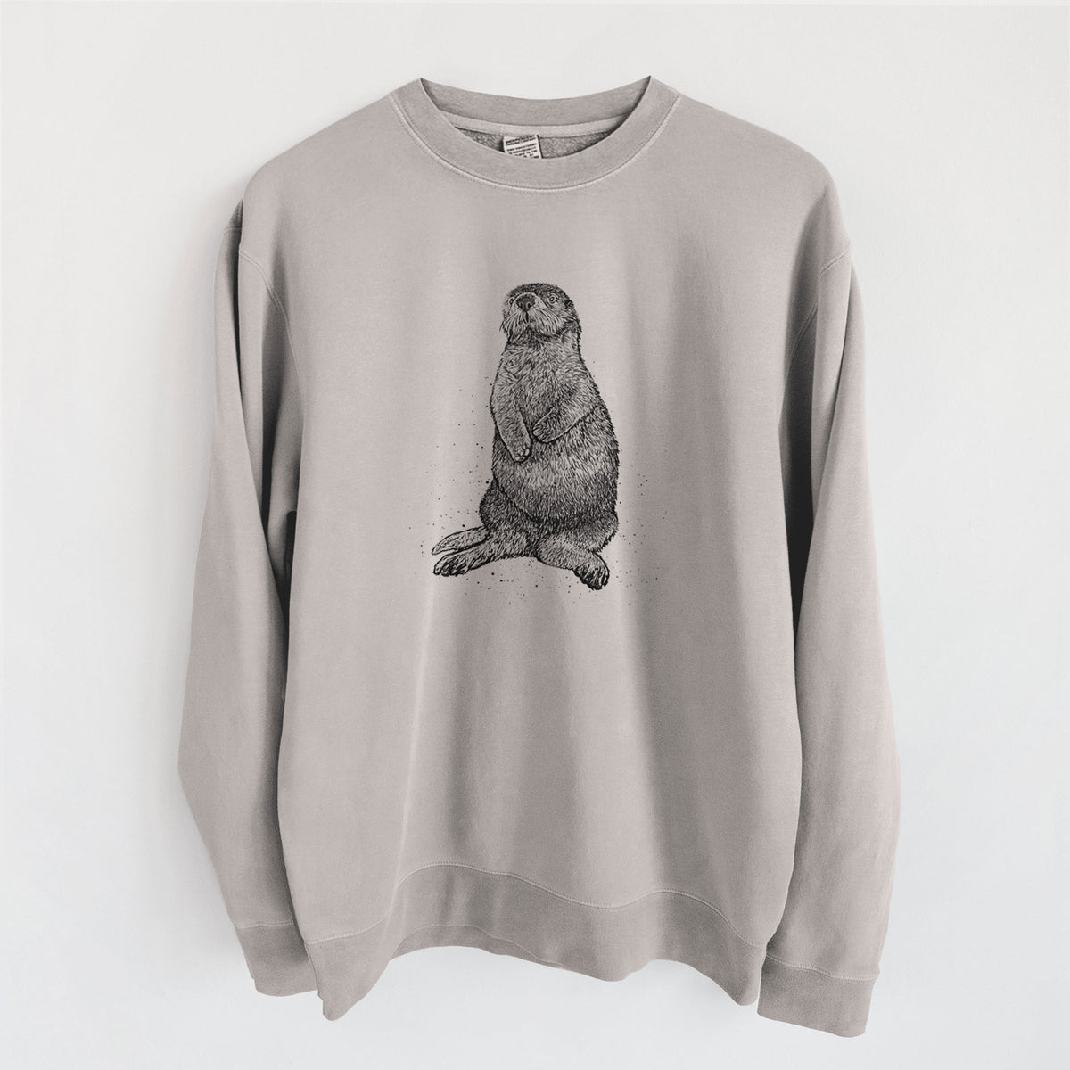 Cement grey pigment dyed crewneck sweatshirt laid flat, printed with a detailed black ink illustration of a sea otter sitting upright.