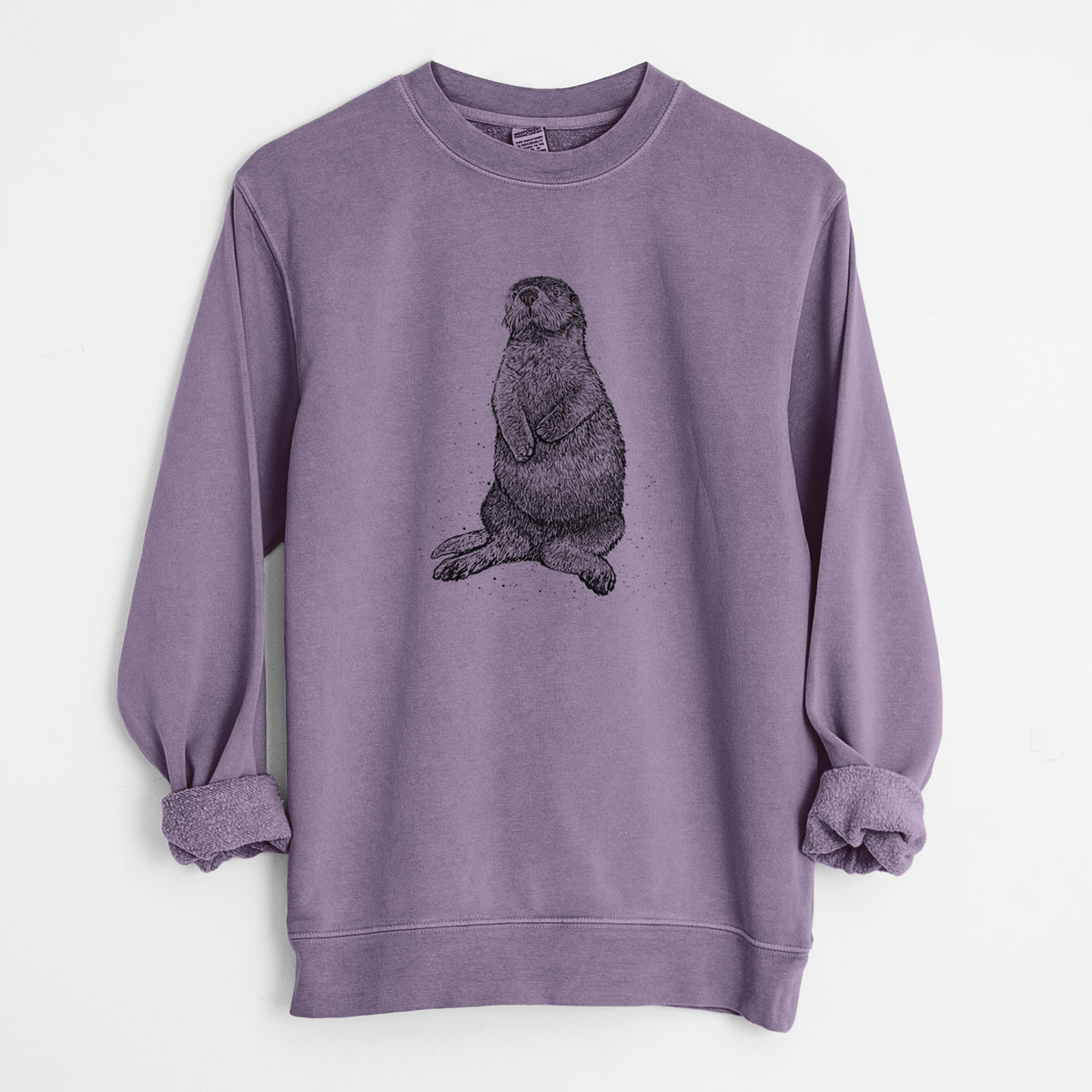 Plum purple pigment dyed crewneck sweatshirt laid flat with the sleeves rolled, printed with a detailed black ink illustration of a sea otter sitting upright.