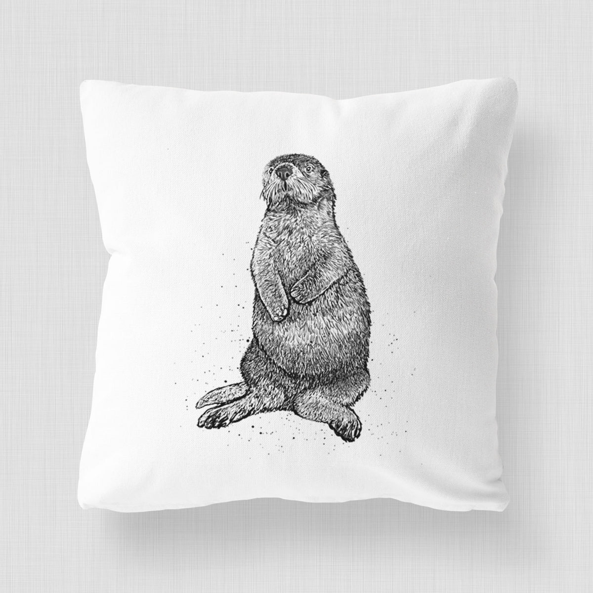 White pillow cover printed with a detailed black ink illustration of a sea otter sitting upright.