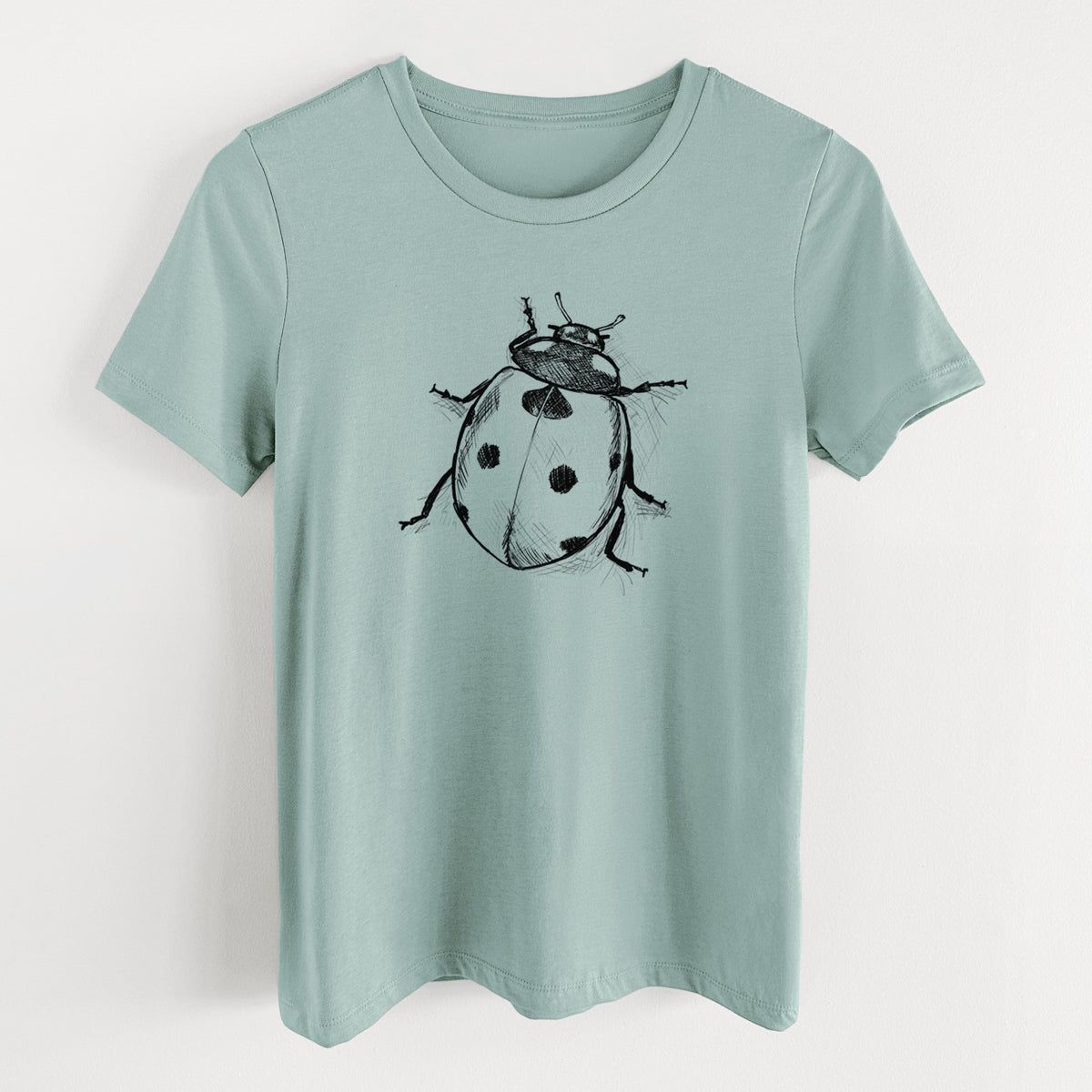 Dusty blue women's relaxed fit cotton t-shirt laid flat, printed with a detailed black ink illustration of a seven-spot ladybird beetle.