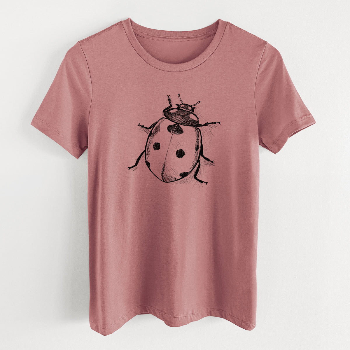 Mauve pink women's relaxed fit cotton t-shirt laid flat, printed with a detailed black ink illustration of a seven-spot ladybird beetle.