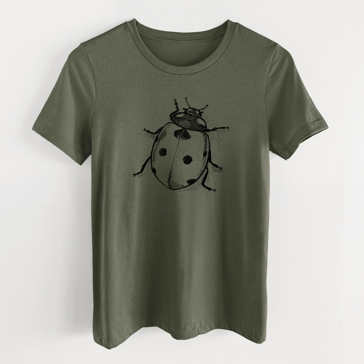 Military green women's relaxed fit cotton t-shirt laid flat, printed with a detailed black ink illustration of a seven-spot ladybird beetle.
