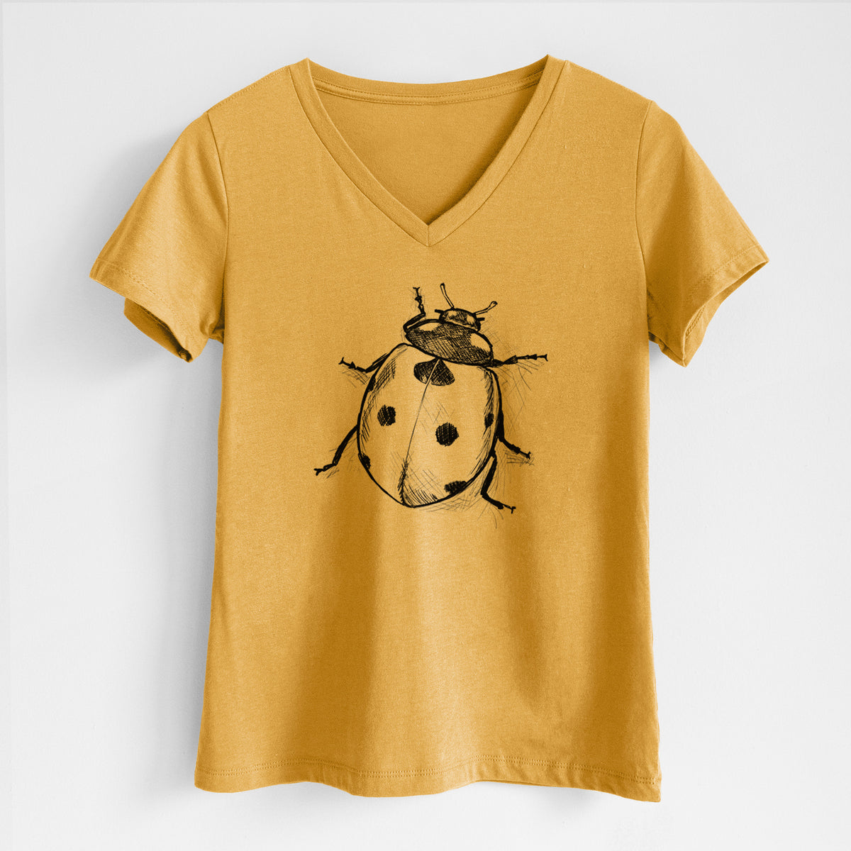 Honeycomb yellow women's relaxed fit cotton V-neck t-shirt laid flat, printed with a detailed black ink illustration of a seven-spot ladybird beetle.