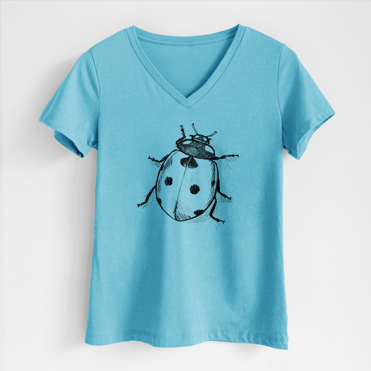 Turquoise women's relaxed fit cotton V-neck t-shirt laid flat, printed with a detailed black ink illustration of a seven-spot ladybird beetle.
