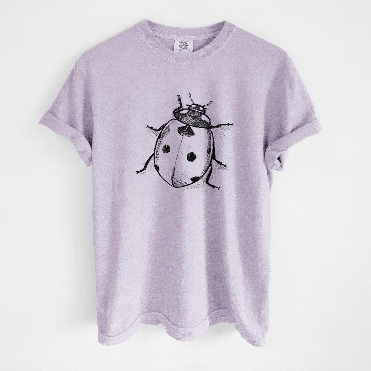Orchid purple Comfort Colors t-shirt laid flat, printed with a detailed black ink illustration of a seven-spot ladybird beetle.