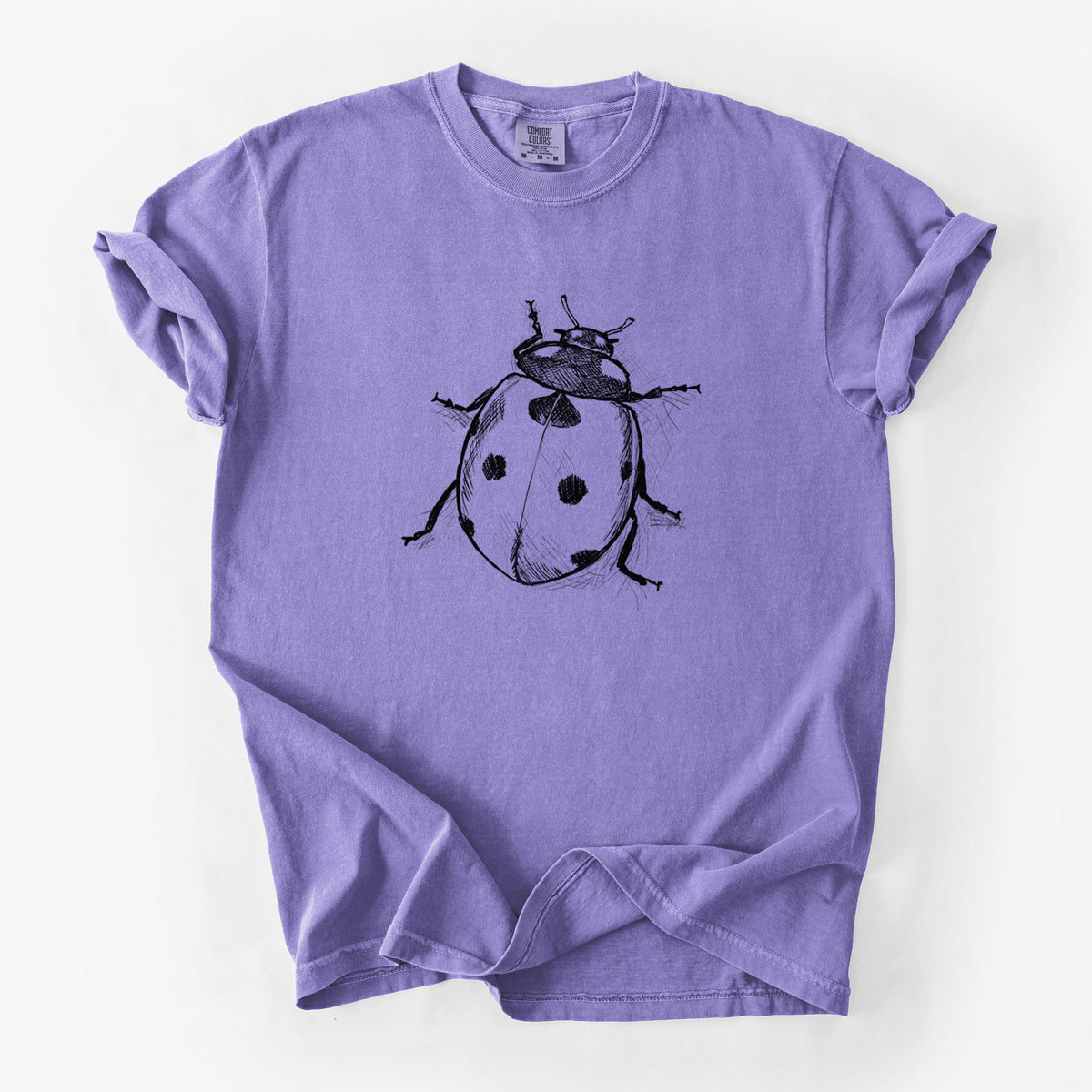 Violet purple Comfort Colors t-shirt laid flat, printed with a detailed black ink illustration of a seven-spot ladybird beetle.