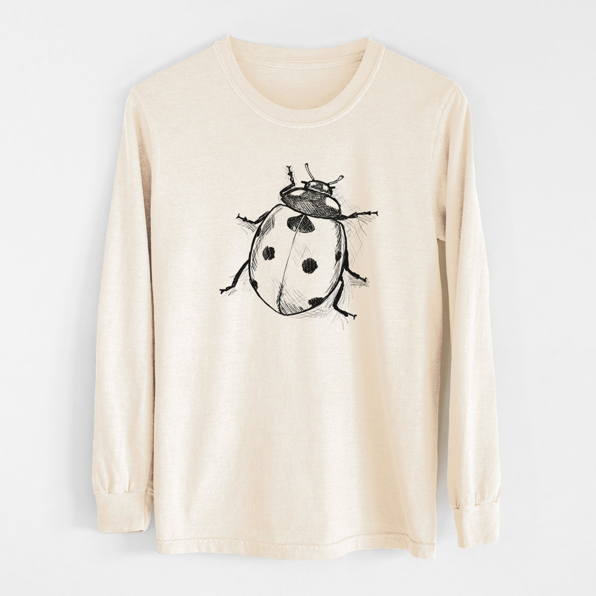 Ivory Comfort Colors long sleeve shirt laid flat, printed with a detailed black ink illustration of a seven-spot ladybird beetle.
