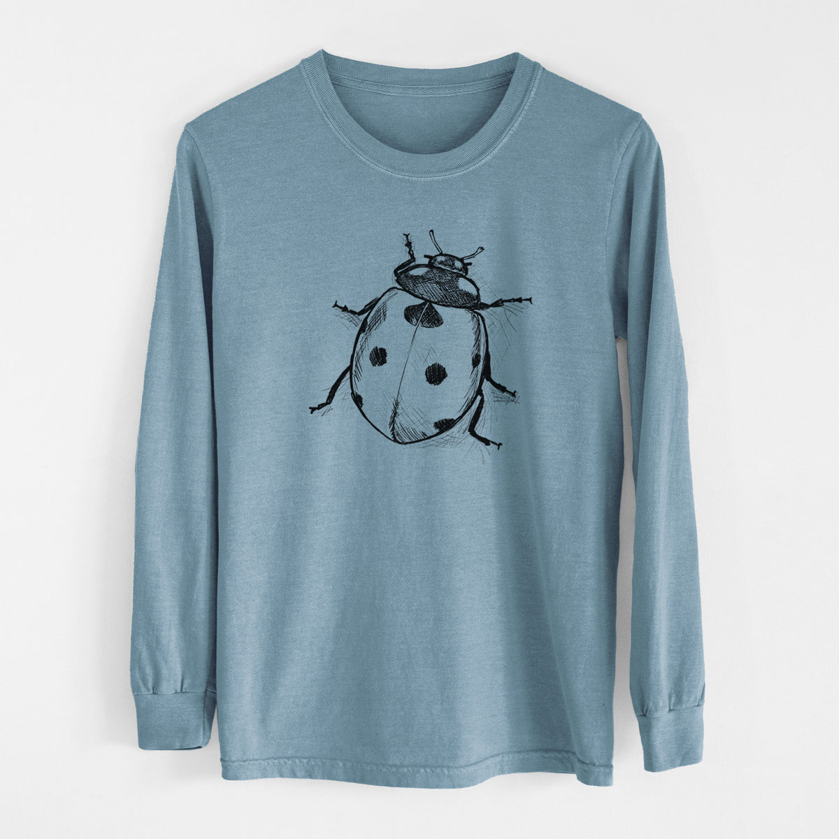Steel blue Comfort Colors long sleeve shirt laid flat, printed with a detailed black ink illustration of a seven-spot ladybird beetle.