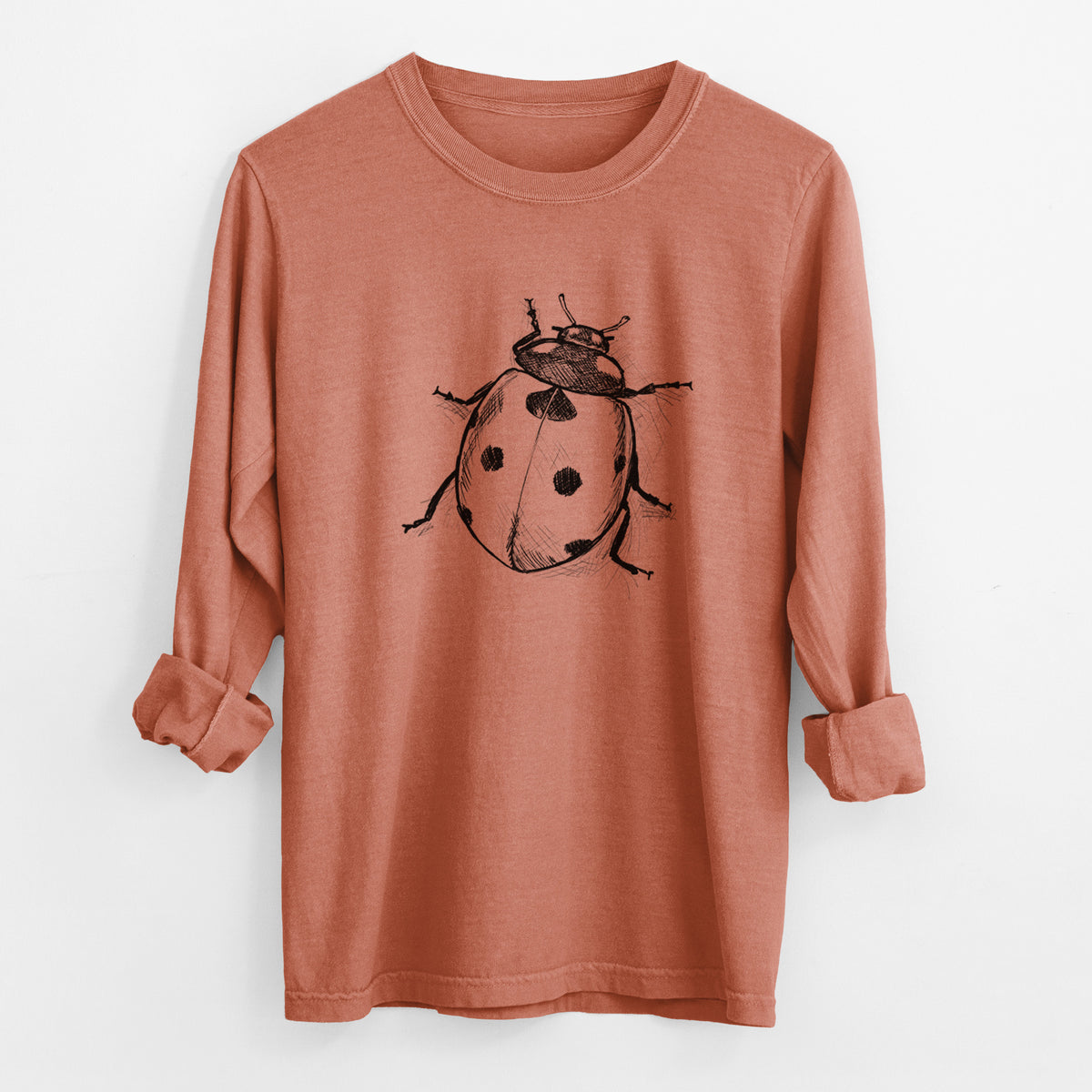 Yam burnt orange Comfort Colors long sleeve shirt laid flat with the cuffs rolled, printed with a detailed black ink illustration of a seven-spot ladybird beetle.