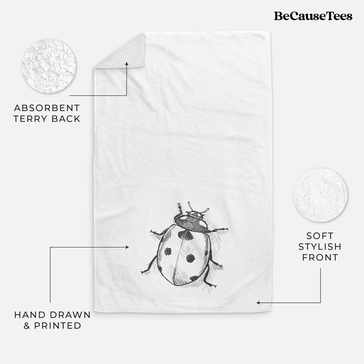 White hand towel printed with a detailed black ink illustration of a seven-spot ladybird beetle.