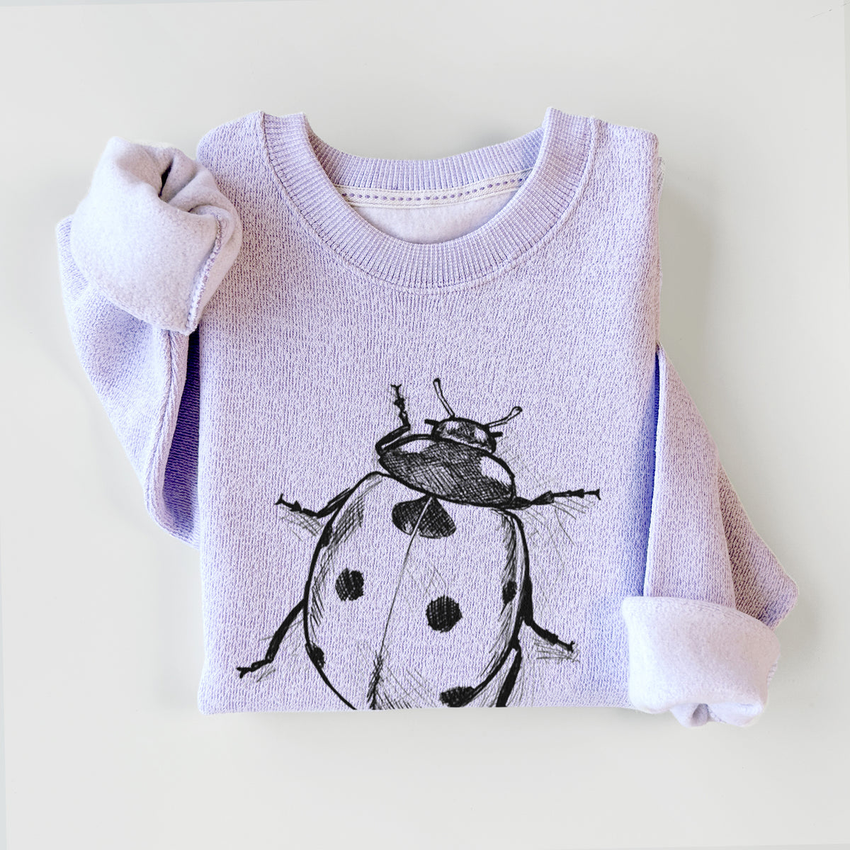 Ice purple knit sweatshirt printed with a detailed black ink illustration of a seven-spot ladybird beetle, styled flat.