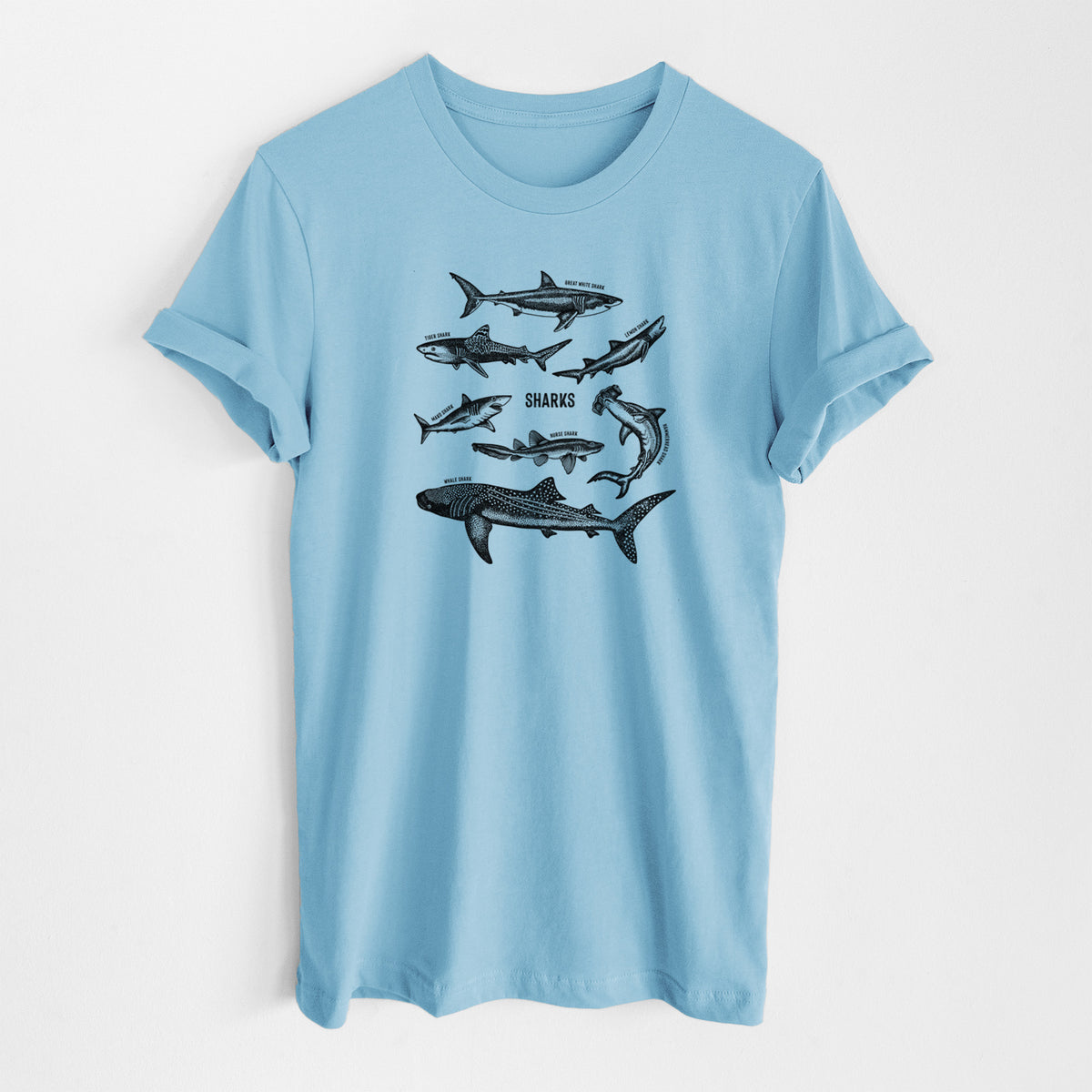 Ocean blue lightweight cotton t-shirt laid flat, printed with a chart of black ink shark illustrations, including a whale shark, hammerhead and great white.