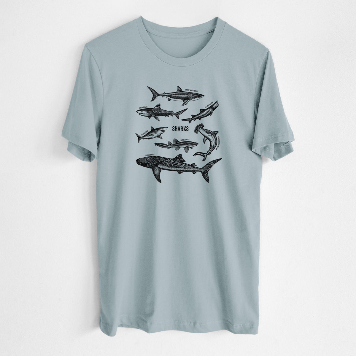 Vintage denim lightweight cotton t-shirt laid flat, printed with a chart of black ink shark illustrations, including a whale shark, hammerhead and great white.