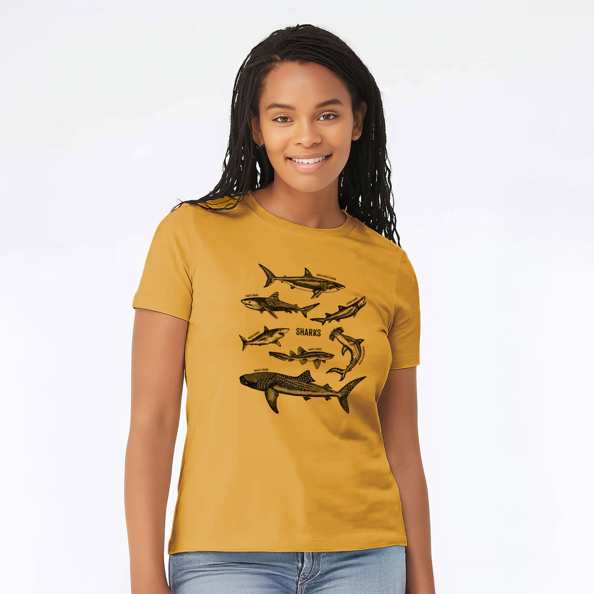 Woman wearing a mustard yellow women's relaxed fit cotton t-shirt printed with a chart of black ink shark illustrations, including a whale shark, hammerhead and great white.