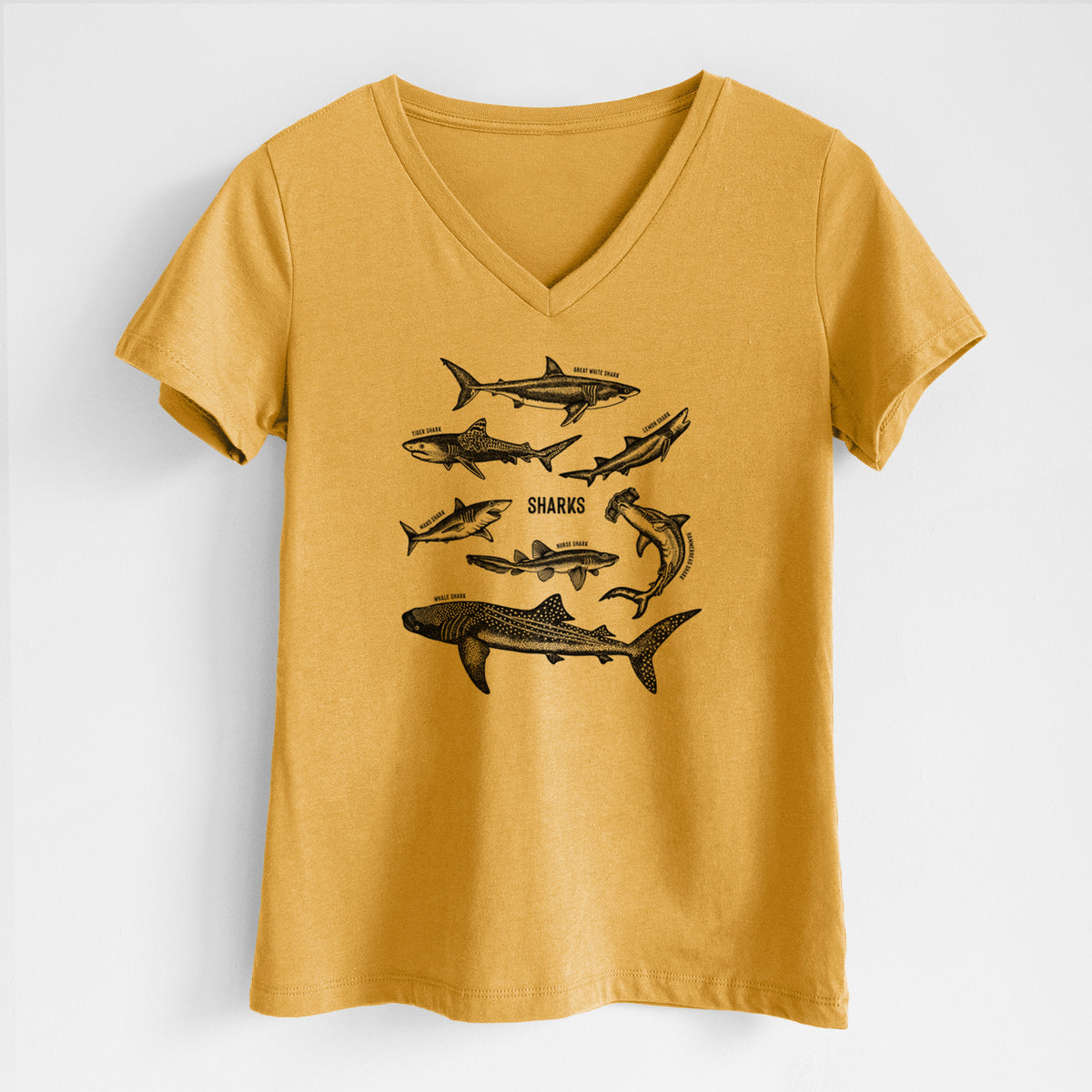 Honeycomb yellow women's relaxed fit cotton V-neck t-shirt laid flat, printed with a chart of black ink shark illustrations, including a whale shark, hammerhead and great white.