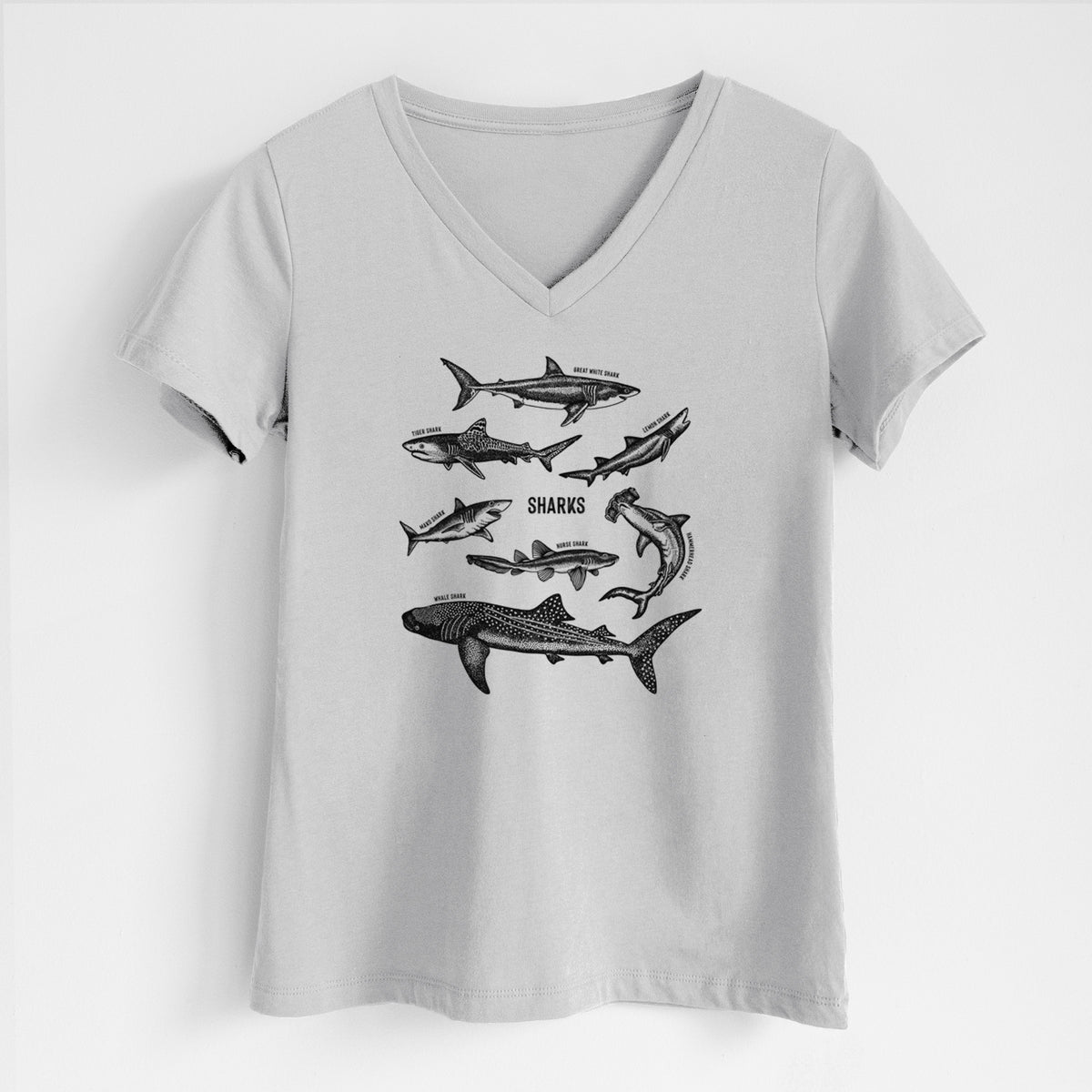 Lunar grey women's relaxed fit cotton V-neck t-shirt laid flat, printed with a chart of black ink shark illustrations, including a whale shark, hammerhead and great white.