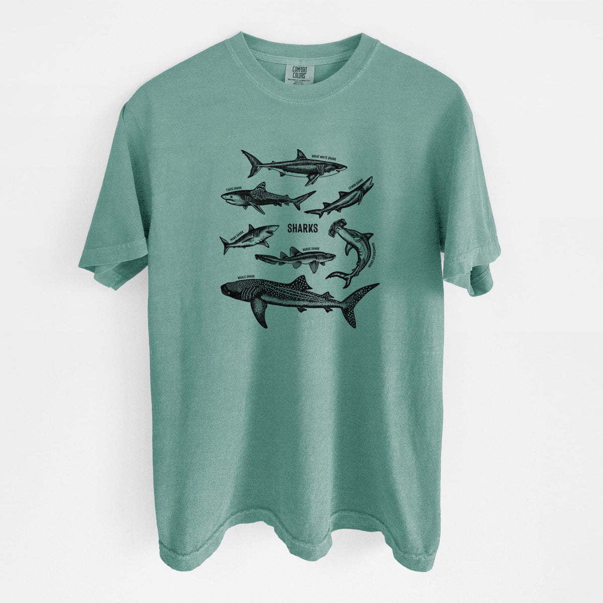 Reef green Comfort Colors t-shirt laid flat, printed with a chart of black ink shark illustrations, including a whale shark, hammerhead and great white.