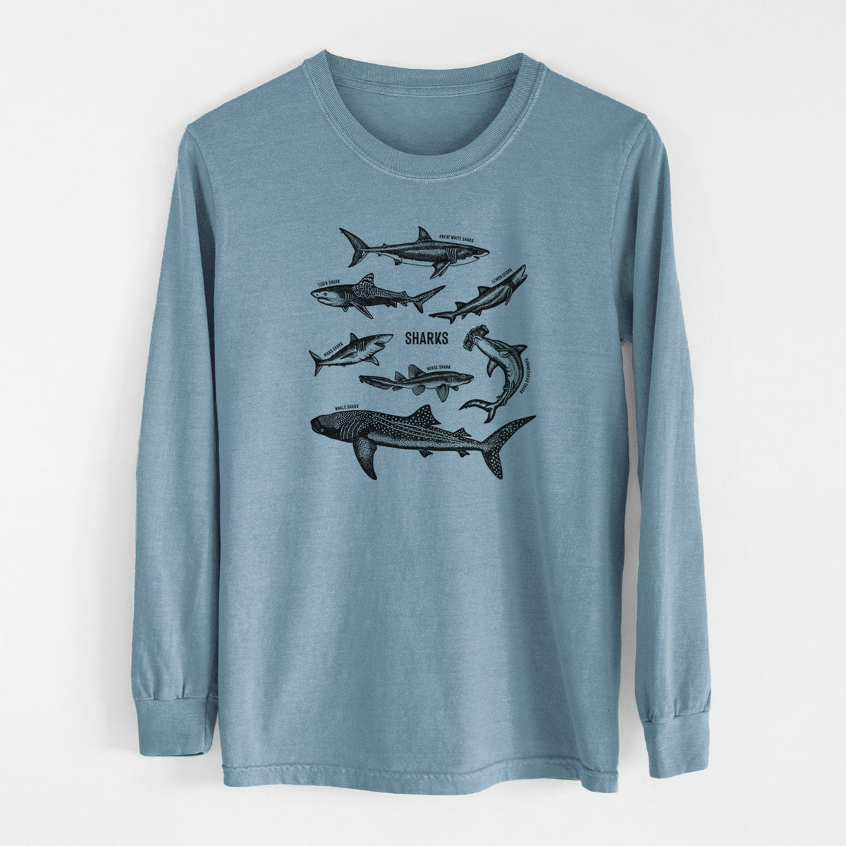 Steel blue Comfort Colors long sleeve shirt laid flat, printed with a chart of black ink shark illustrations, including a whale shark, hammerhead and great white.
