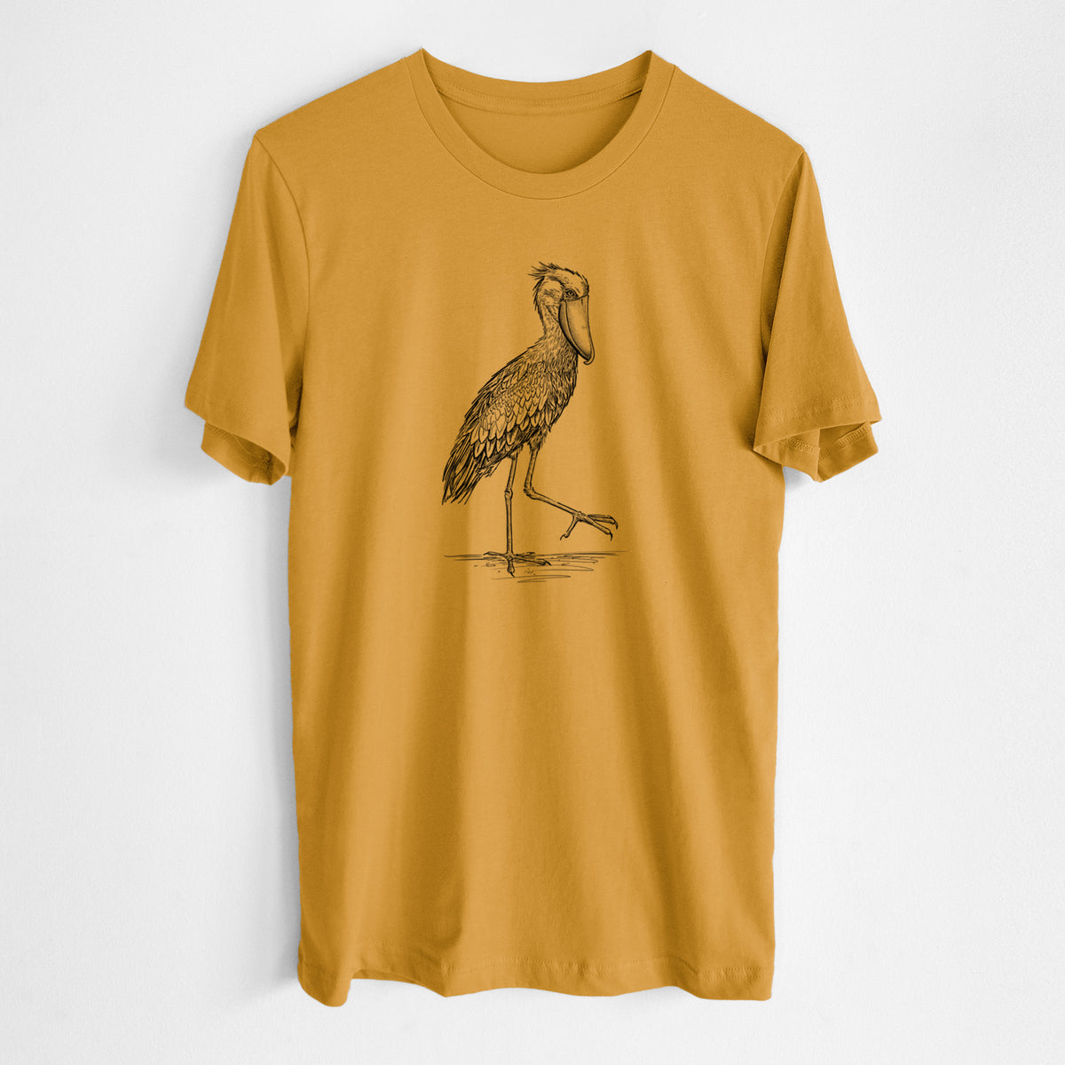 Honeycomb yellow lightweight cotton t-shirt laid flat, printed with a black ink illustration of a shoebill stork standing on one leg.