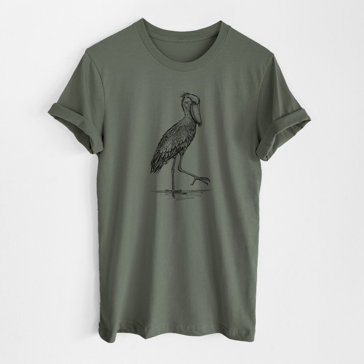 Military green lightweight cotton t-shirt laid flat, printed with a black ink illustration of a shoebill stork standing on one leg.