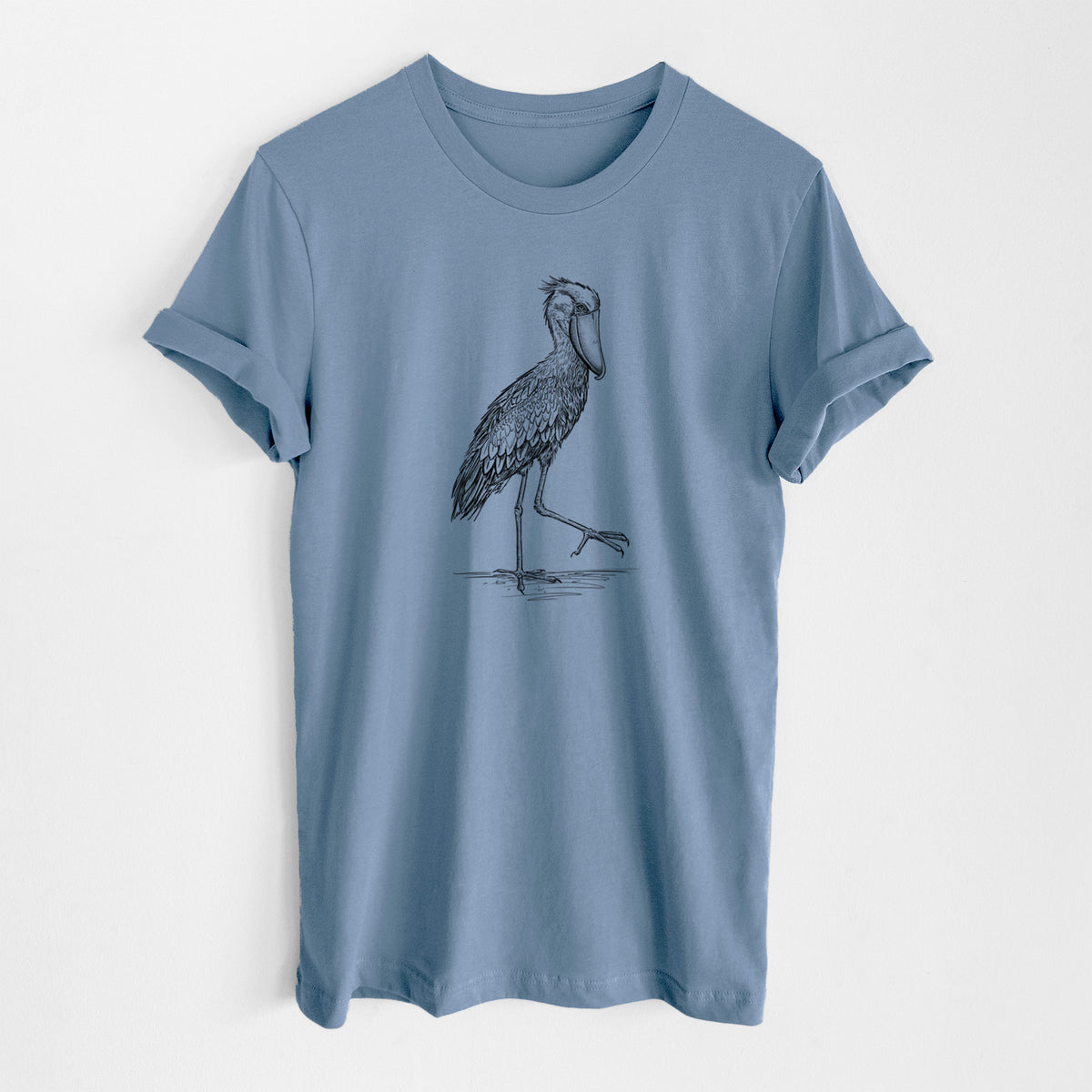 Steel blue lightweight cotton t-shirt laid flat, printed with a black ink illustration of a shoebill stork standing on one leg.