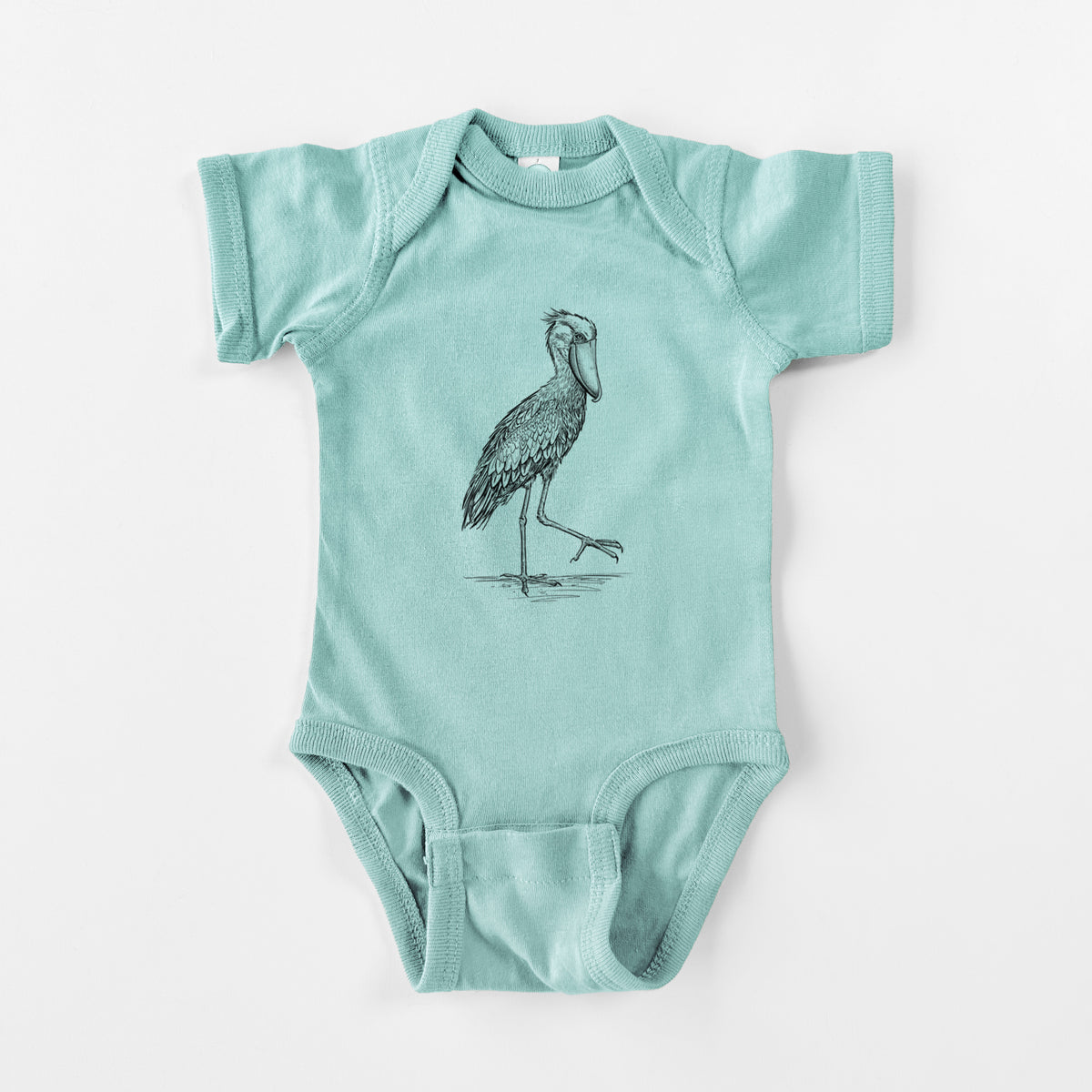Saltwater baby bodysuit laid flat, printed with a black ink illustration of a shoebill stork standing on one leg.
