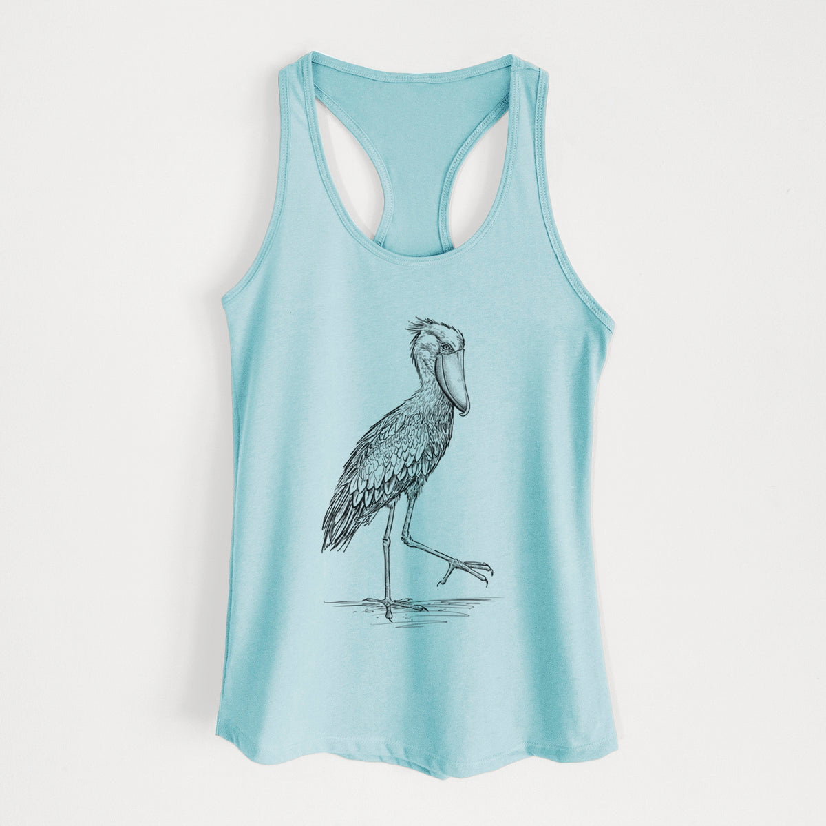 Cancun blue women's racerback tank top laid flat, printed with a black ink illustration of a shoebill stork standing on one leg.