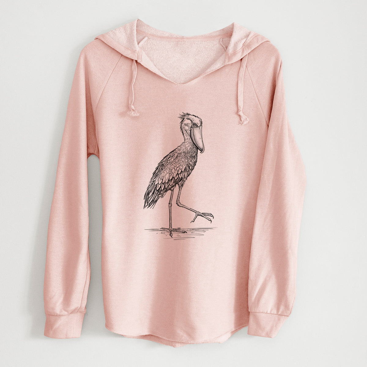 Blush pink women's Cali Wave hooded sweatshirt laid flat, printed with a black ink illustration of a shoebill stork standing on one leg.