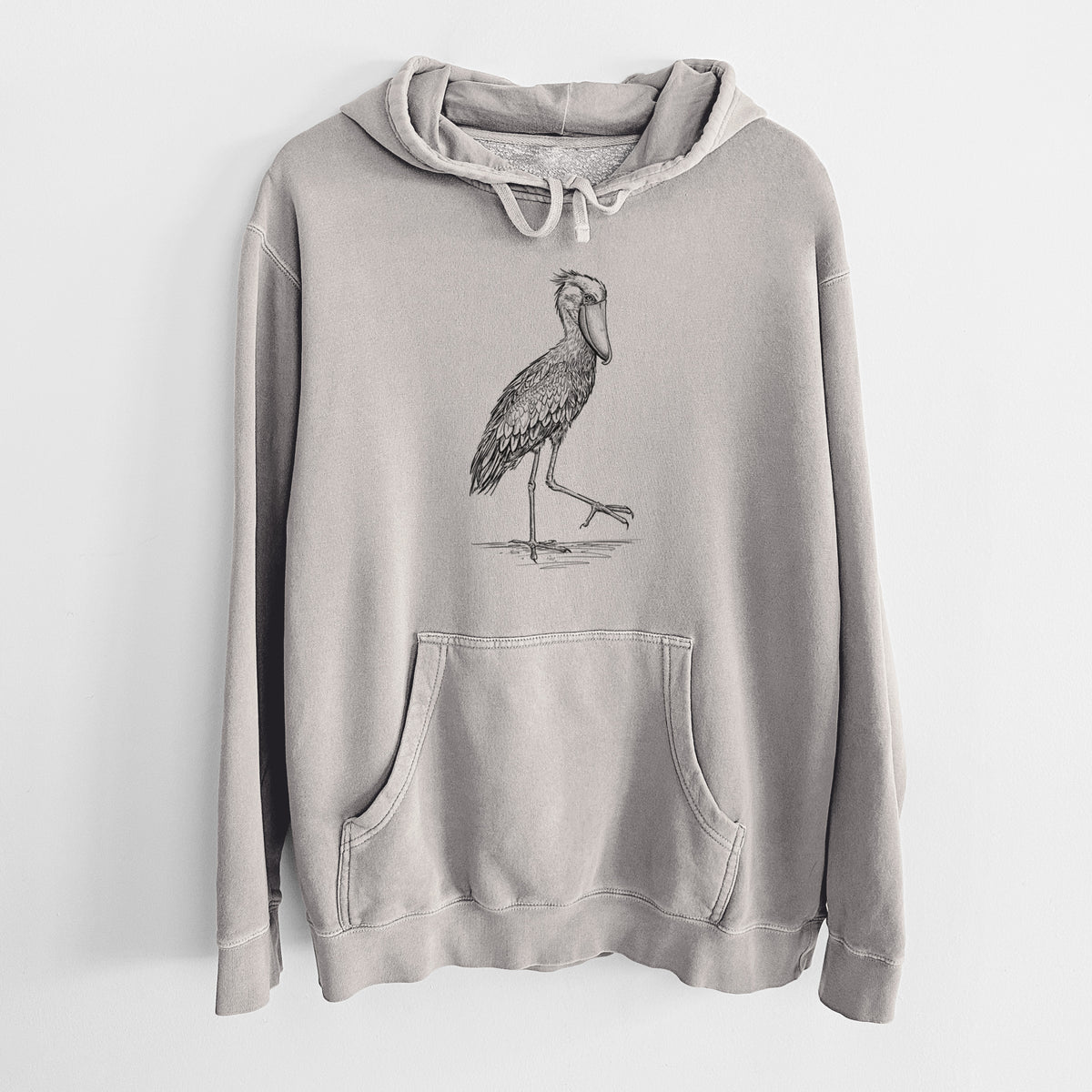 Cement grey pigment dyed hoodie laid flat, printed with a black ink illustration of a shoebill stork standing on one leg.