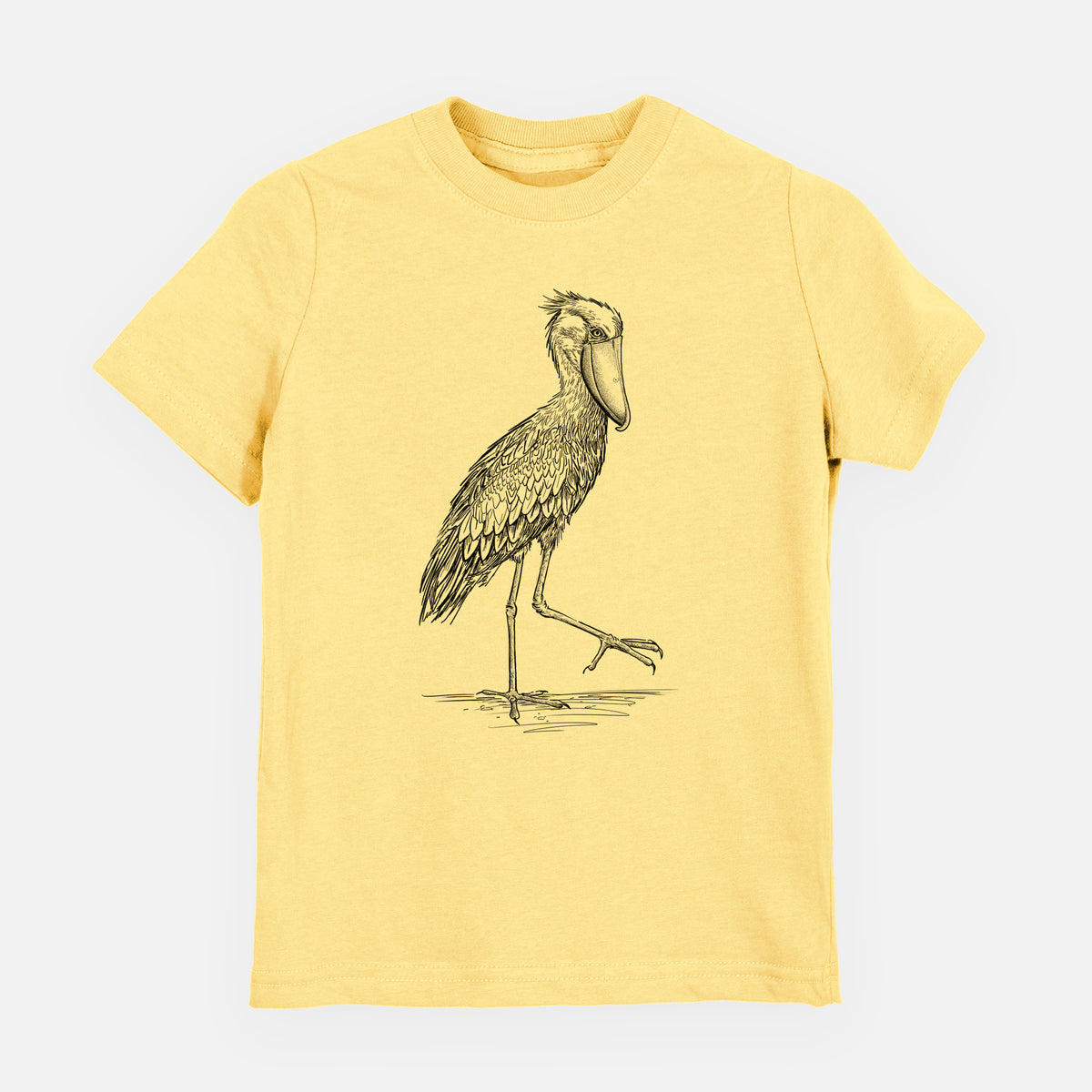 Butter yellow youth t-shirt laid flat, printed with a black ink illustration of a shoebill stork standing on one leg.