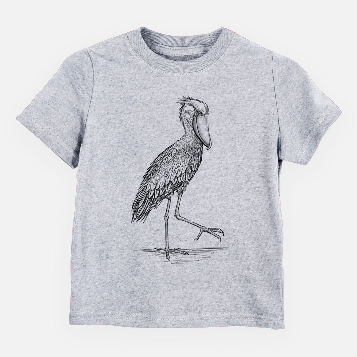 Heather grey toddler t-shirt laid flat, printed with a black ink illustration of a shoebill stork standing on one leg.