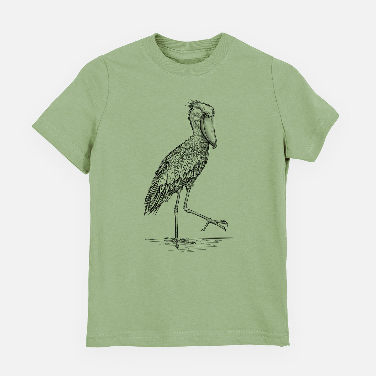 Sage green youth t-shirt laid flat, printed with a black ink illustration of a shoebill stork standing on one leg.