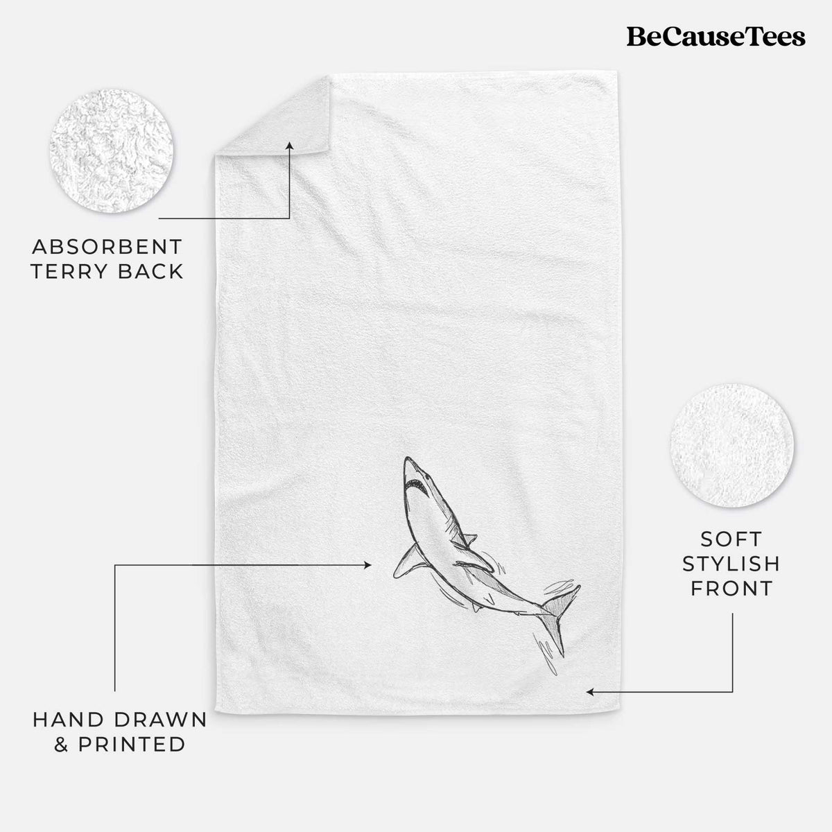 White hand towel printed with a black ink illustration of a shortfin mako shark diving.