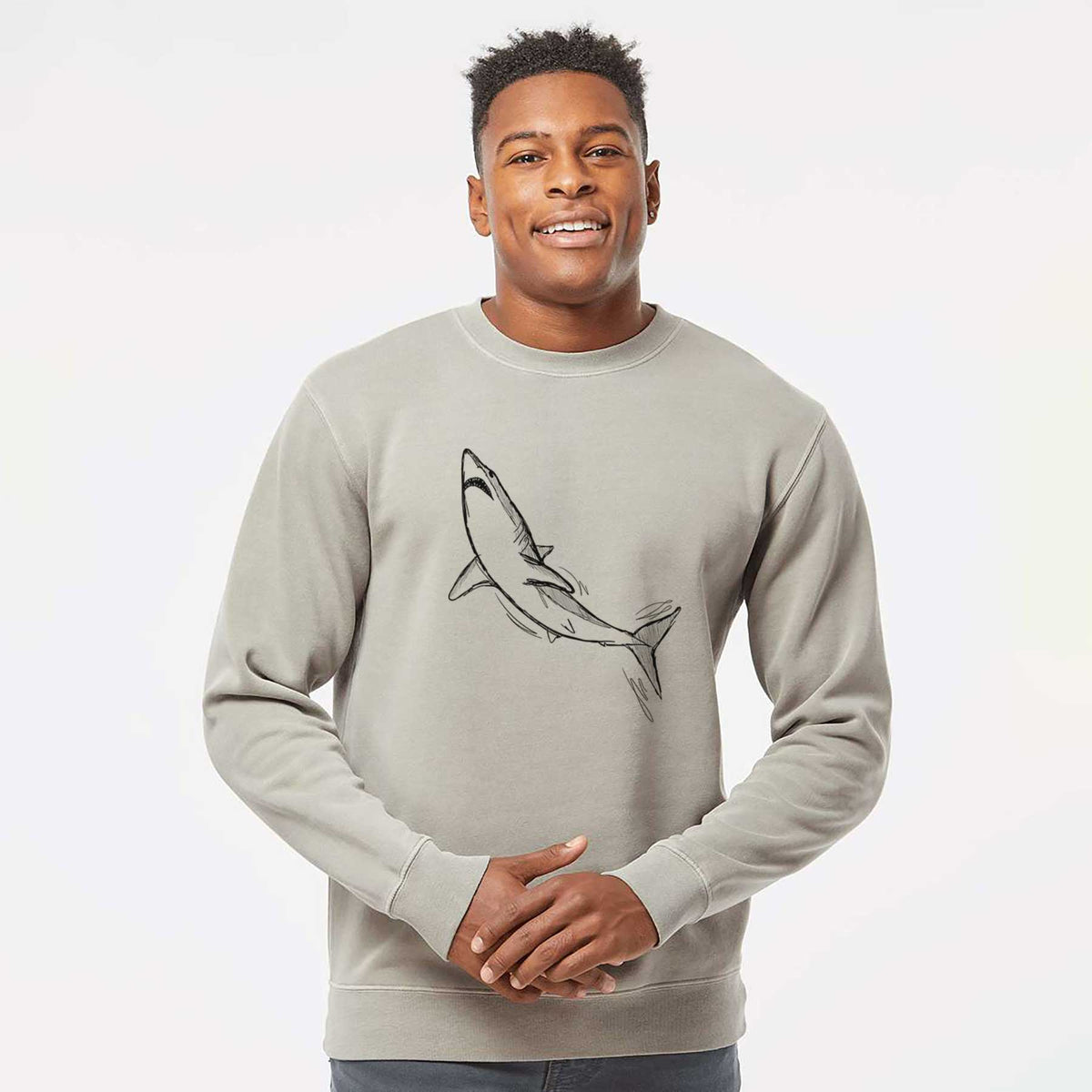 Model wearing a cement grey pigment dyed crewneck sweatshirt printed with a black ink illustration of a shortfin mako shark diving.