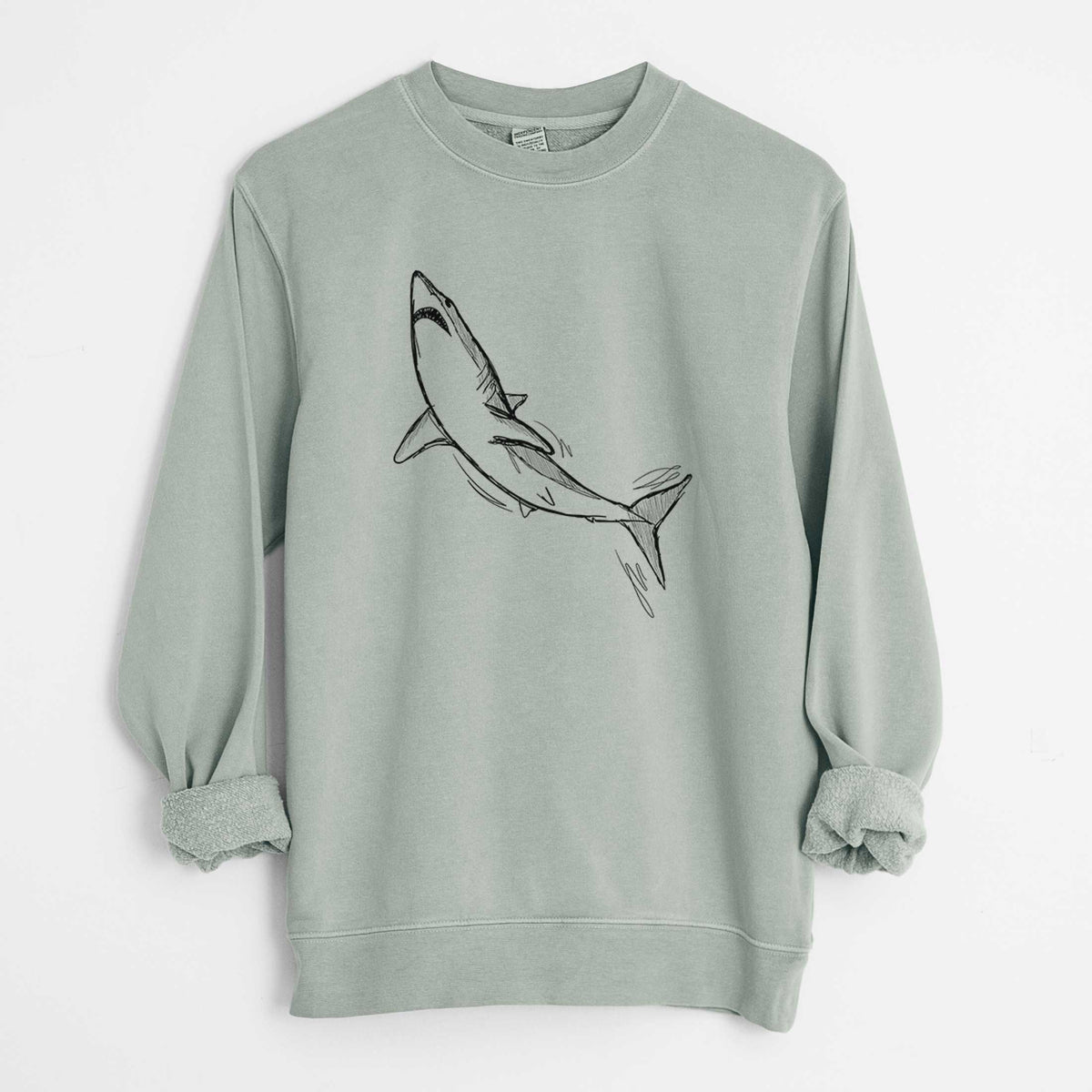 Sage green pigment dyed crewneck sweatshirt laid flat with the sleeves rolled, printed with a black ink illustration of a shortfin mako shark diving.